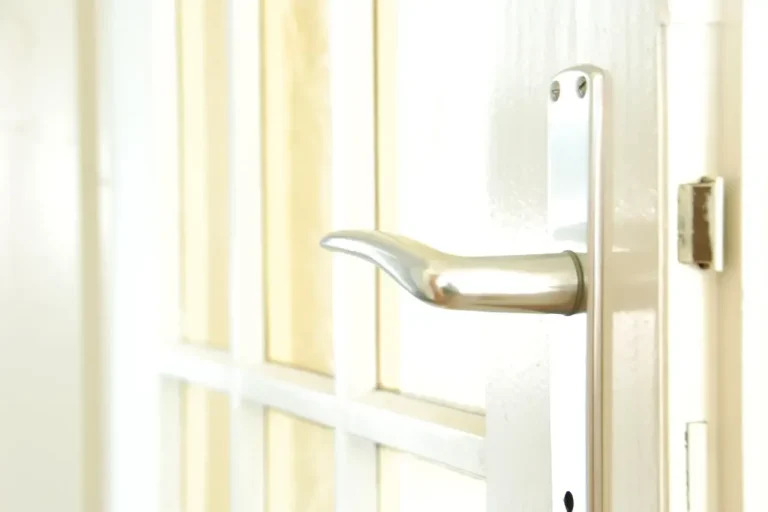 Lock repair or replacement in Birmingham – white door with a lever handle and locking plate, Locksmith Birmingham guide to which your door needs